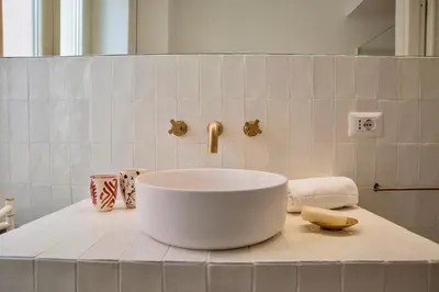 a white sink on a counter in a bathroom at RELAIS DEI GOTI in Rome