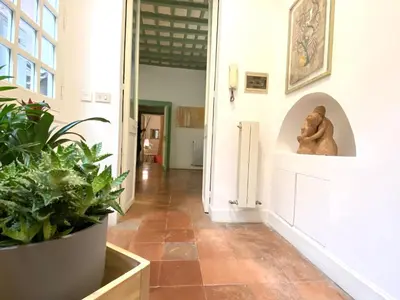 a hallway with plants and a statue on the wall at Pantheon Ancient Rome Apartment in Rome