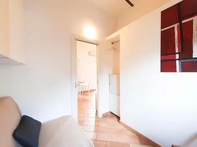 a living room with a couch and a hallway at Cozy Apartment in Pigneto up to 4 in Rome