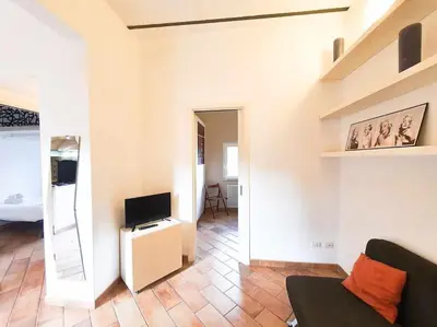 a living room with a couch and a television at Cozy Apartment in Pigneto up to 4 in Rome