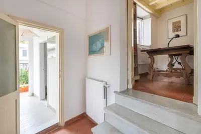 a hallway with a staircase and a piano in a house at Bright Penthouse Downtown in Rome