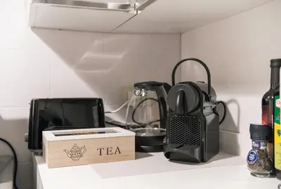 a tea box sitting on top of a kitchen counter at Campo de' Fiori appartamento via di Grotta Pinta in Rome