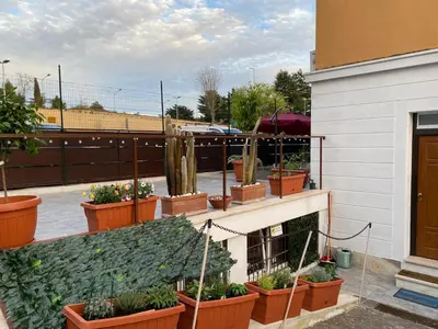 a group of potted plants on a building at OFFICINALE Rome Apartment, Pineta Sacchetti in Rome