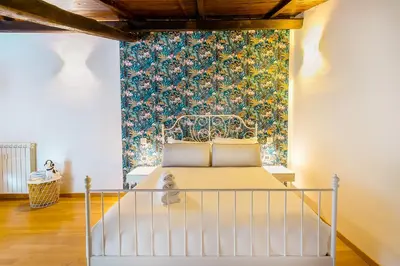 a bedroom with a bed and a wall mural at Magikrooms Muse in Rome