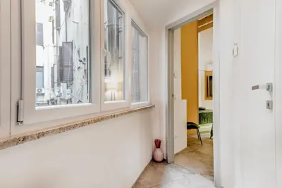an empty hallway with a window and a room at TH Trastevere Luxury-S.Cosimato 2bd-2bt in Rome