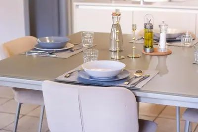 a dining table with plates and bowls on it at Ottavia al Foro - Luxury Property in Rome