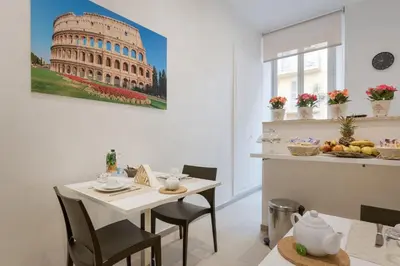 a dining room with a table and a picture of the coliseum at Le Stanze di Rinaldo in Rome