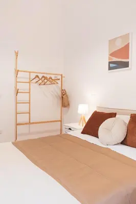 a bedroom with a bed with a wooden headboard at Gazometro Rome Holiday House - Rome Vacation M&D in Rome