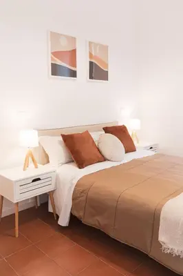 a bedroom with a large bed and a table with two lamps at Gazometro Rome Holiday House - Rome Vacation M&D in Rome