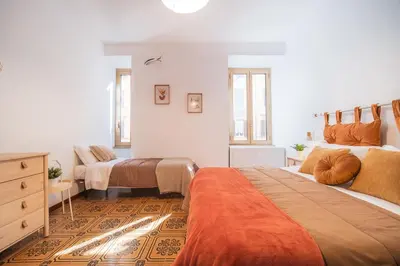 a bedroom with two beds and a dresser at Gazometro Rome Holiday House - Rome Vacation M&D in Rome