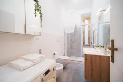 a white bathroom with a toilet and a sink at Gazometro Rome Holiday House - Rome Vacation M&D in Rome