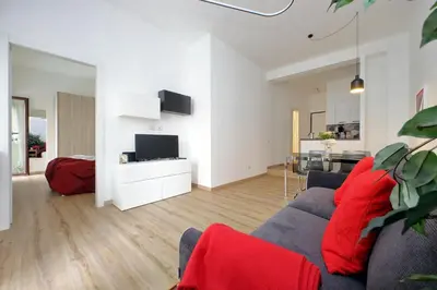 a living room with a blue couch and red pillows at 4BNB - Cozy Albornoz Flat in Rome