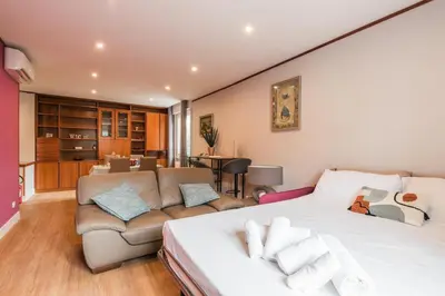 a bedroom with a large bed and a couch at Daniela's Place in Rome