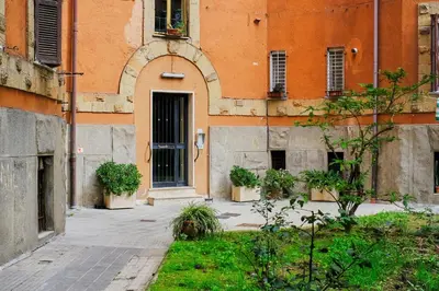 an orange building with a door and plants in front of it at Remuria Domus in Rome