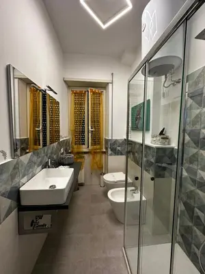 a bathroom with two sinks and two toilets at DOMUS H501 in Rome
