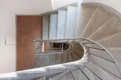 a spiral staircase in a building with a metal railing at Residenza Urbana in Rome