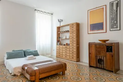 a bedroom with a bed and a dresser at Residenza Urbana in Rome