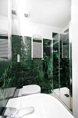 a bathroom with a toilet and a glass shower at St Peter Regal Apartment in Rome