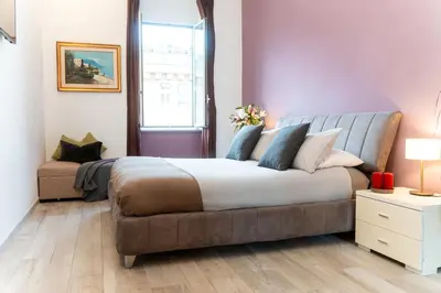 a bedroom with a large bed and a window at C&Y Apartments - Roma Vaticano St Peter - Luxe Penthouse Flat in Rome
