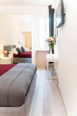 a bedroom with a bed and a living room at C&Y Apartments - Roma Vaticano St Peter - Luxe Penthouse Flat in Rome