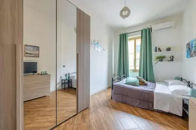 a bedroom with a bed and a sliding glass door at Colosseo Roma color's in Rome