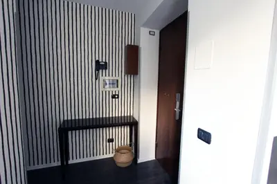 a hallway with a black and white striped wall at Avignonesi Flat in Rome