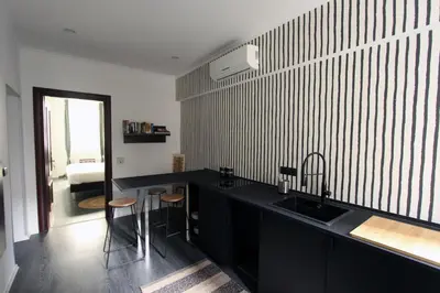 a kitchen with a black counter and a sink at Avignonesi Flat in Rome