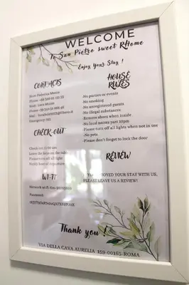 a white framed menu for a wedding reception at San Pietro Sweet RHome in Rome