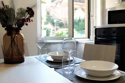 a table with two plates and glasses on it at San Pietro Sweet RHome in Rome