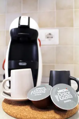 a counter with two cups and a coffee maker at San Pietro Sweet RHome in Rome