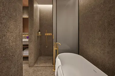 a bedroom with wooden walls and a bed with flowers at The Rome EDITION in Rome