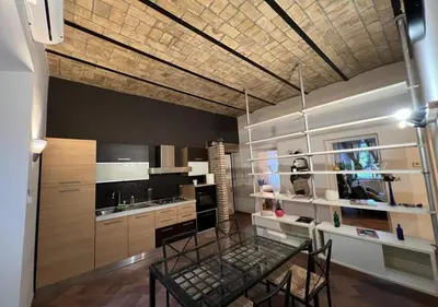 a kitchen with a glass table in a room at StarHome San Paolo in Rome