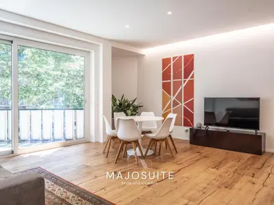 a living room with a table and chairs and a tv at Majo Suite in Rome