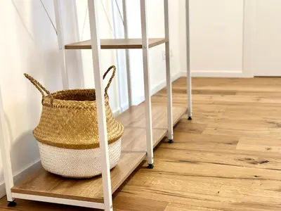 a basket on a wooden floor next to a stair case at Majo Suite in Rome