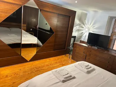 a hotel room with a bed and a mirror at Garden House Trastevere in Rome
