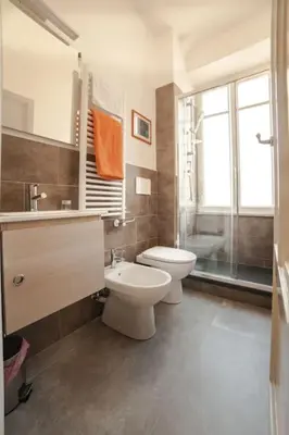 a bathroom with a toilet and a sink and a shower at Monti Coliseum 2nd floor 3 bedroom in Rome