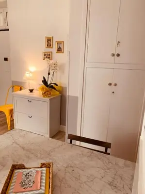 a room with a dresser and a cabinet with a mirror at A casa di Clara in Rome
