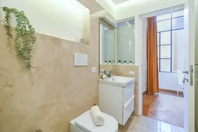 a bathroom with a toilet and a sink at Suite 109 in Rome
