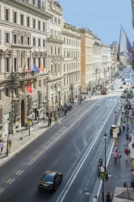 a car driving down a city street with buildings at Suite 109 in Rome