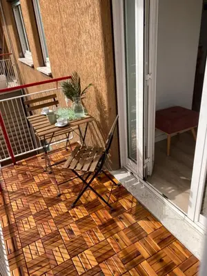 a patio with a table and a chair on a balcony at Casetta Marconi Trentotto in Rome