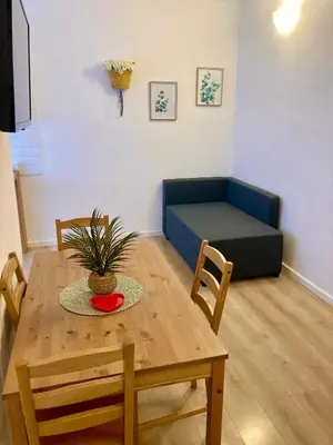 a living room with a table and a couch at Casetta Marconi Trentotto in Rome
