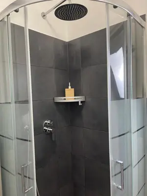 a shower with a glass door in a bathroom at Henry Suite in Rome