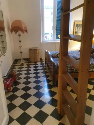 a room with a bunk bed and a checkered floor at Home Rome Lepanto in Rome