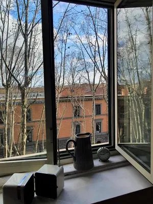 a window with a view of a brick building at Home Rome Lepanto in Rome