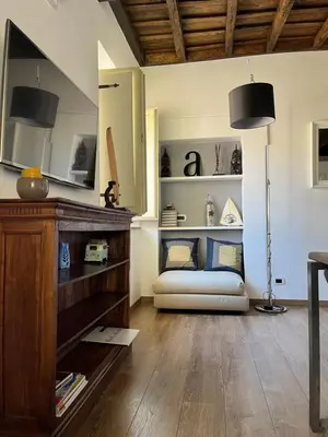 a living room with a couch and a table at Colosseo Suite in Rome
