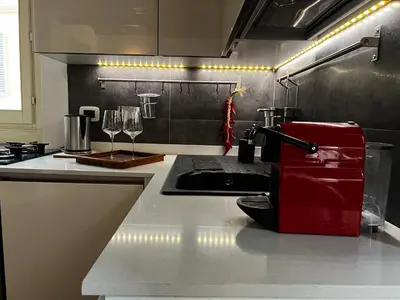 a kitchen with a red appliance on a counter at Colosseo Suite in Rome