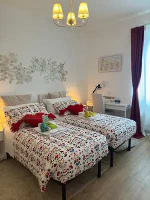 a bedroom with two beds and a table with food on them at Gemelli-San Pietro-Trastevere-casa con posto auto in Rome