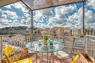 a table and chairs on a balcony with a view of a city at Matilde's view apartment Saint Peter in Rome