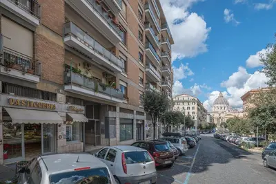 a street with cars parked on the side of a building at Matilde's view apartment Saint Peter in Rome