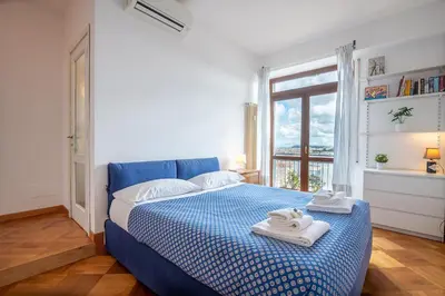 a bedroom with a blue bed with towels on it at Matilde's view apartment Saint Peter in Rome